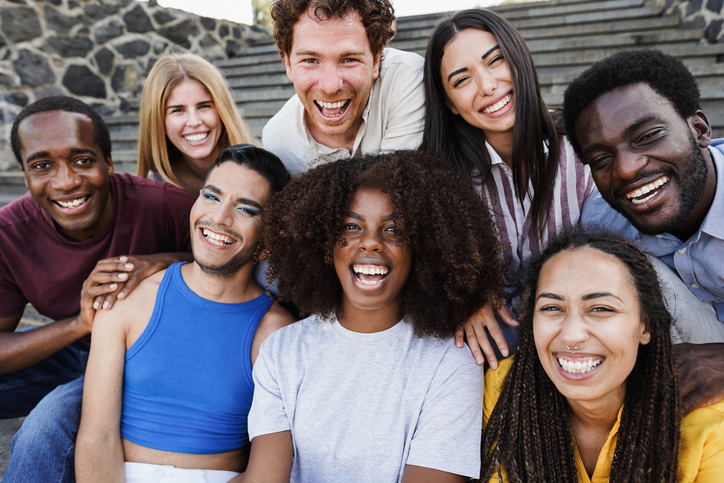 Young diverse people having fun outdoor laughing together - Diversity concept - Main focus on african girl face